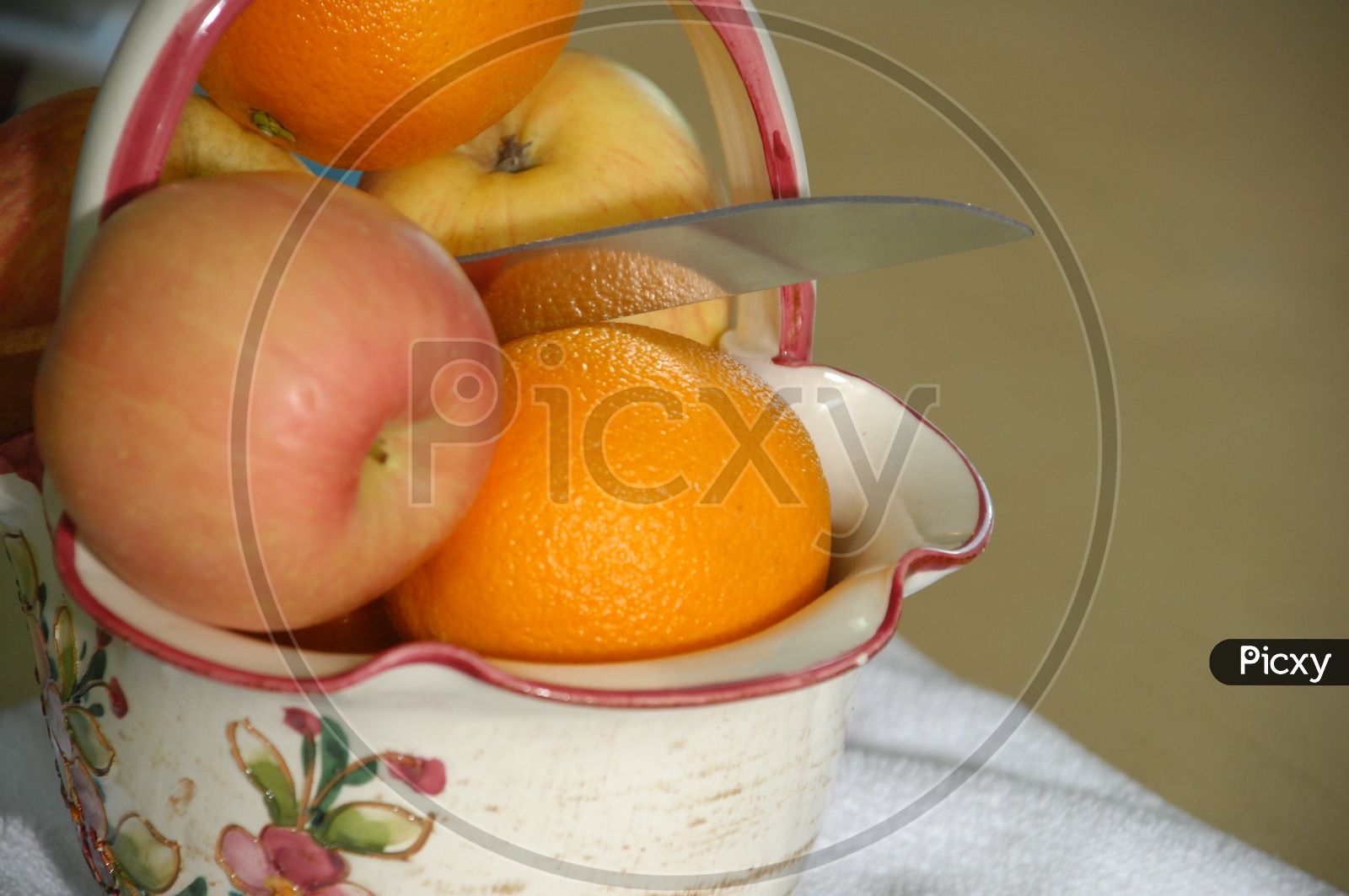 Close up shot of Fresh fruits in a basket with knife