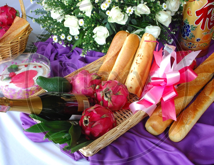 Bread Sticks With Dragon Fruit , avocado and Wine Bottle Presentation in a Basket