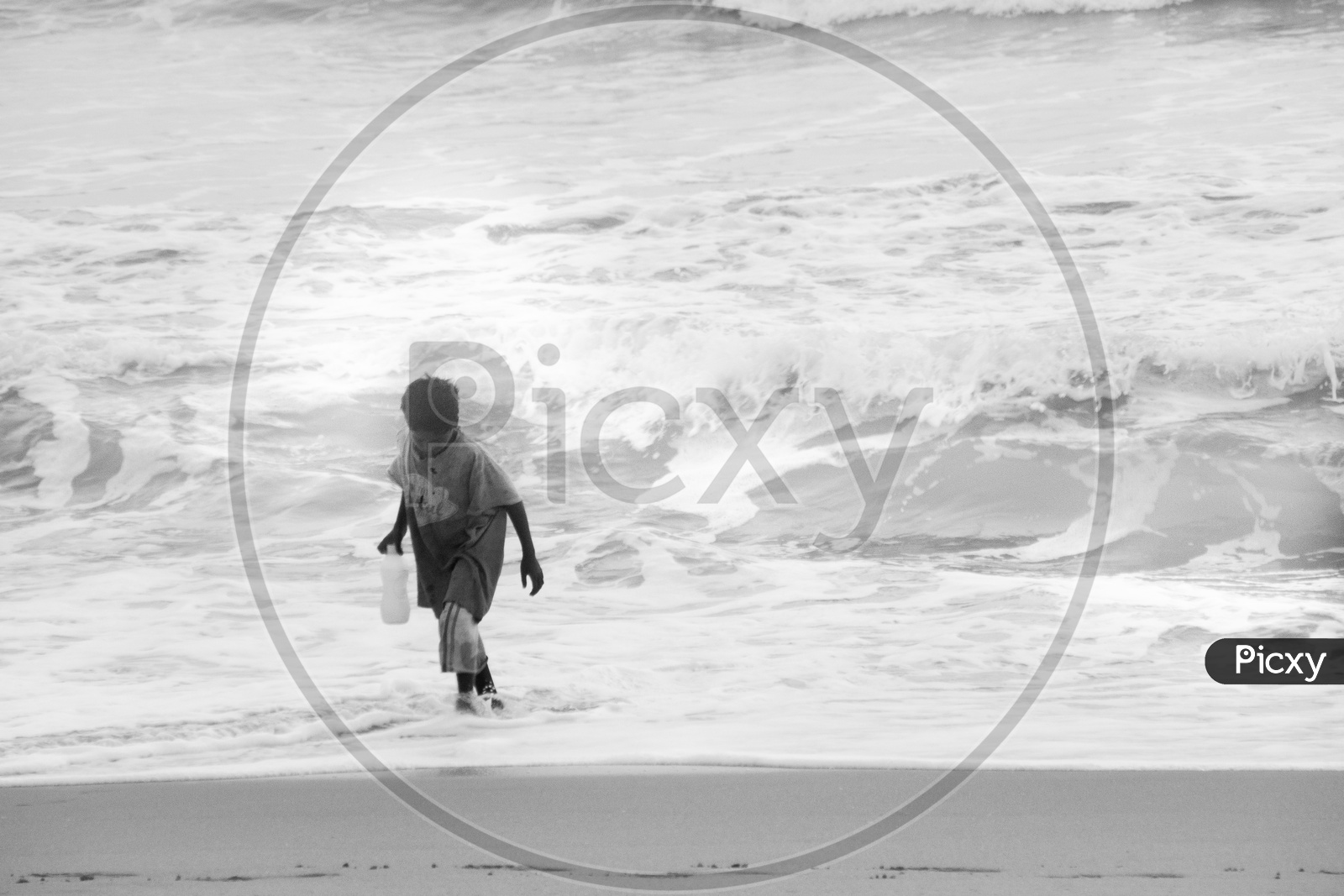 Boy taking water from beach