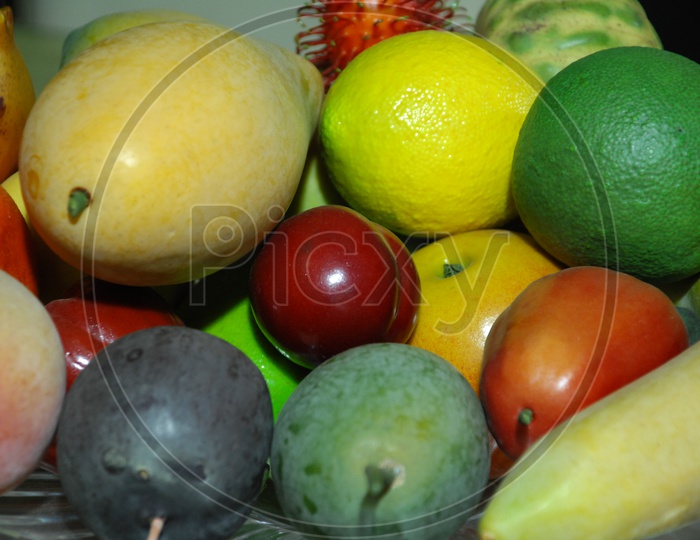 Artificial fruits placed in a bowl