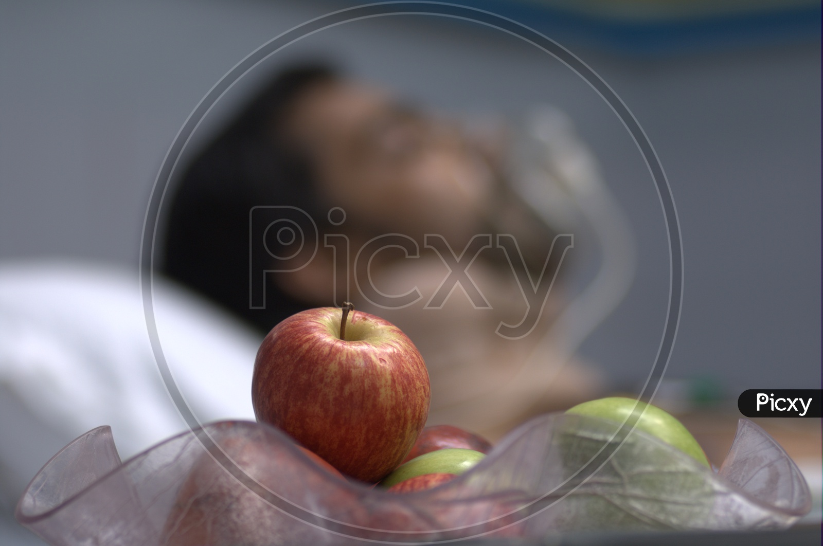 Close up shot of Apple fruit with man in the background