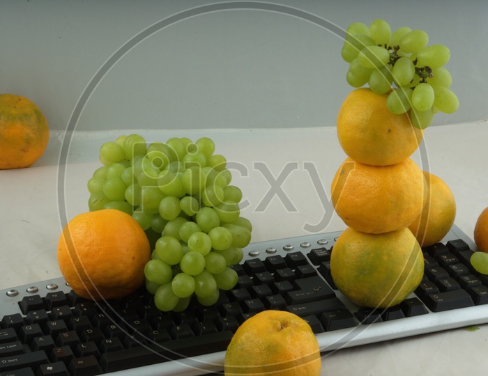 Oranges and grape fruits on Keyboard