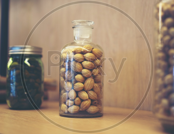 Cardamom in a Glass Jar At Kitchen Table