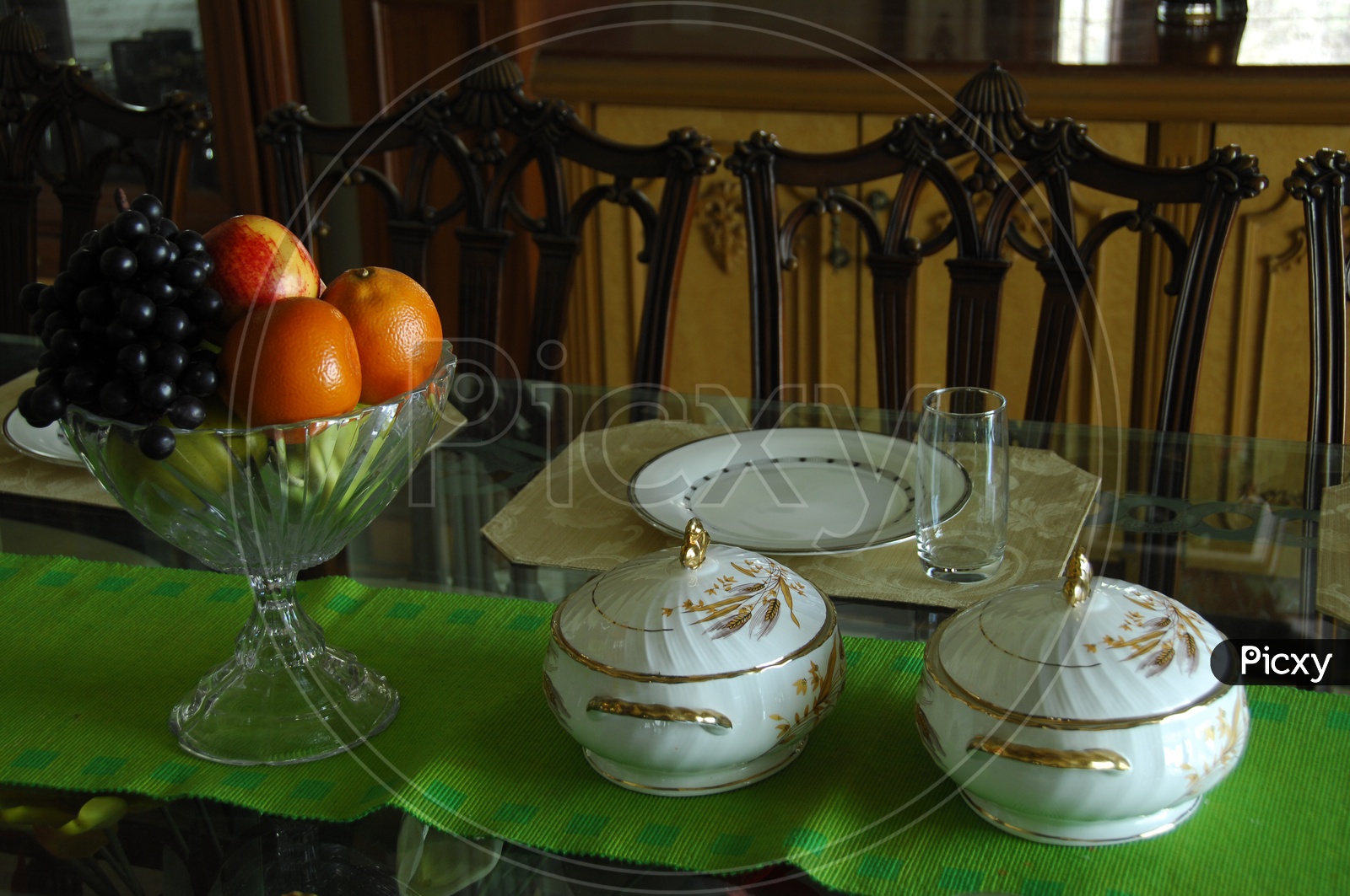 Photograph of Dining table with fresh fruits in a glass bowl