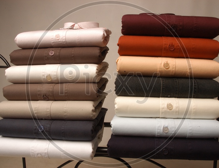 Stack of folded men's cotton shirts in multi color