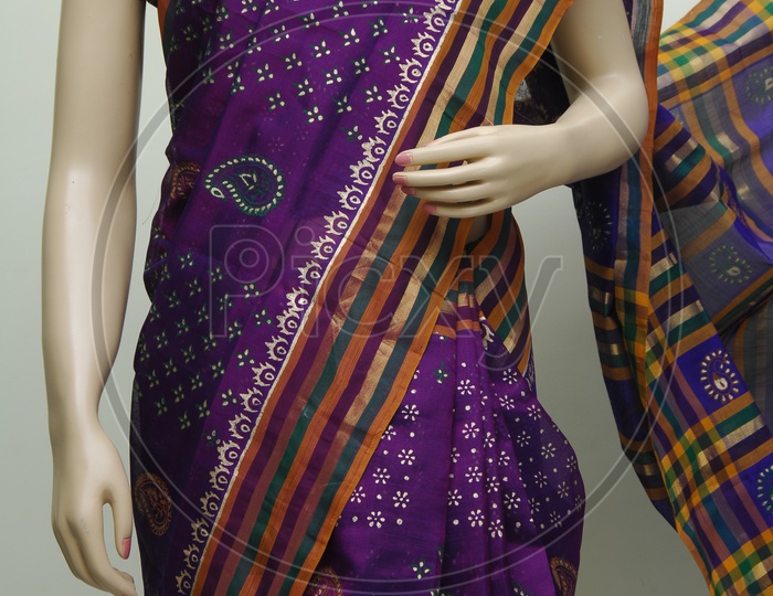 Close up shot of a Mannequin draped in a traditional Indian violet saree
