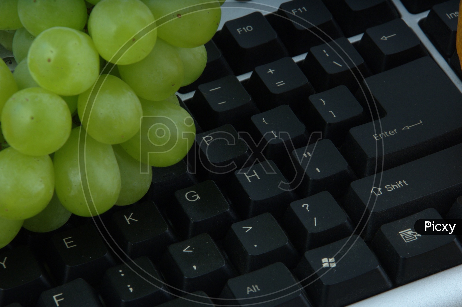 photograph of grapes on a  computer keyboard