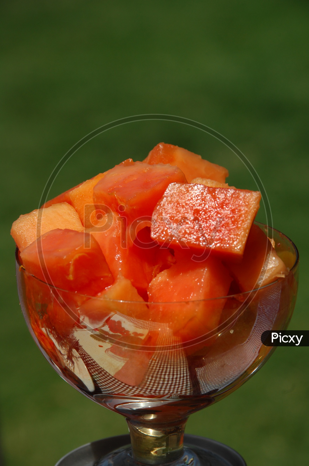Papaya fruit pieces in a glass cup