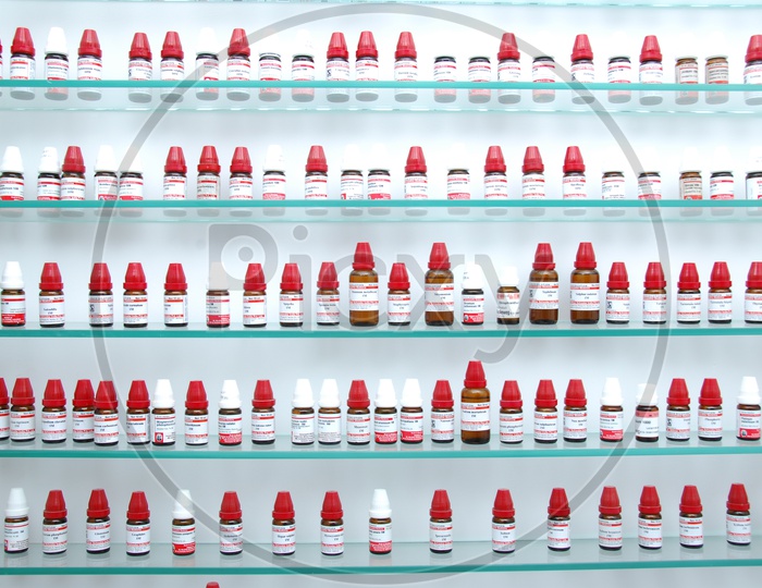 Homeopathy Medicine Bottles in Racks In Pharmacy