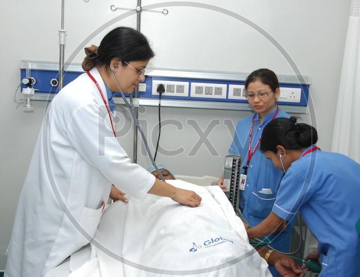 Doctors Checking Patient In a Hospital ICU