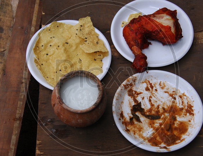 Fried Chicken Leg Piece With Indian Spices Served With Butter Milk in a Clay pot