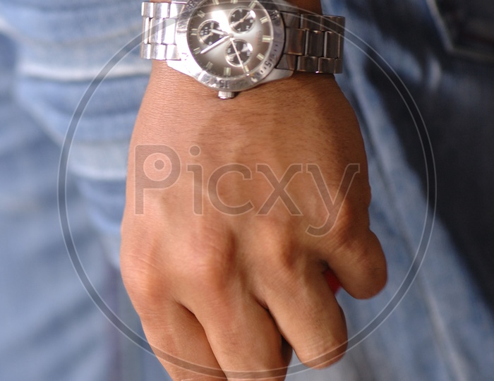Hand of a man with a steel watch