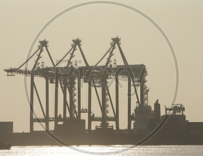 Silhouette Of Heavy Cranes in Port