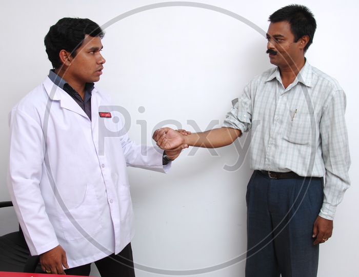 Doctor checking the pulse of a patient