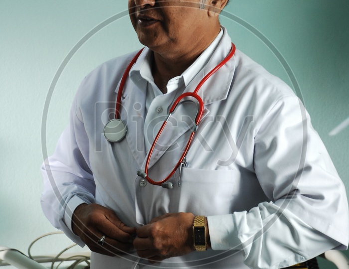An actor as a  doctor with a white coat and stethoscope - movie scene