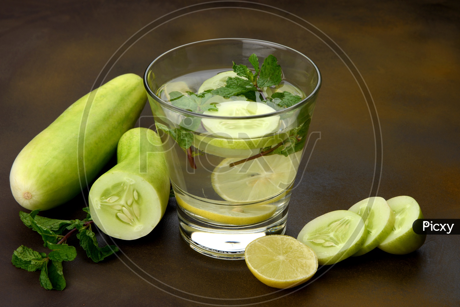A glass of water with Cucumber, Lemon and Mint leaf