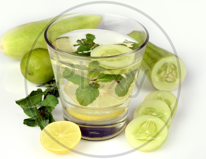 A glass of water with Cucumber, Lemon and Mint leaf