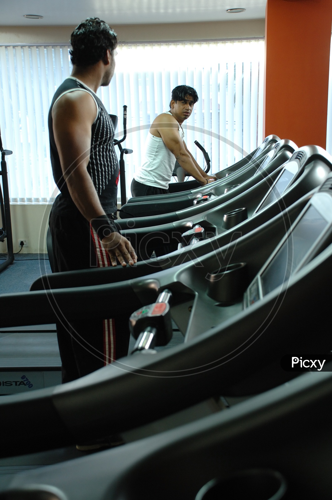 Indian men exercising at a gym