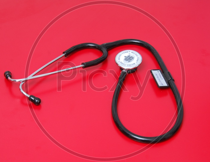 Photograph of stethoscope on red background