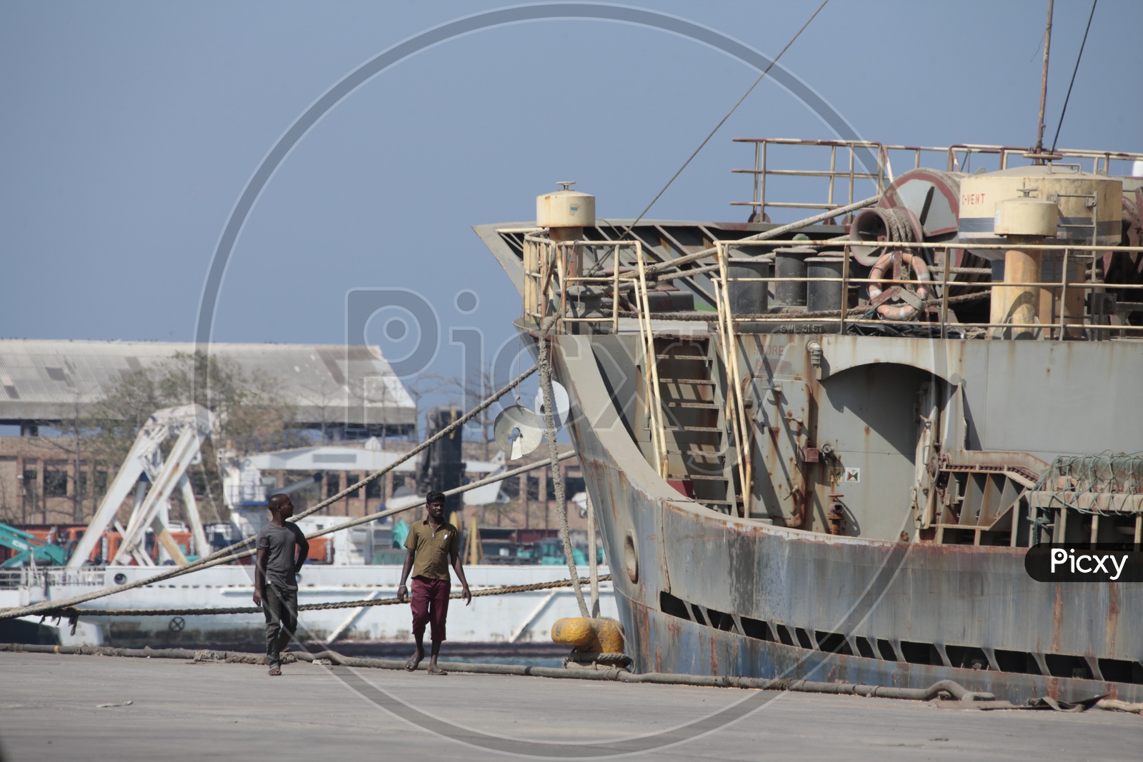 Local people walking alongside the ship by the port area
