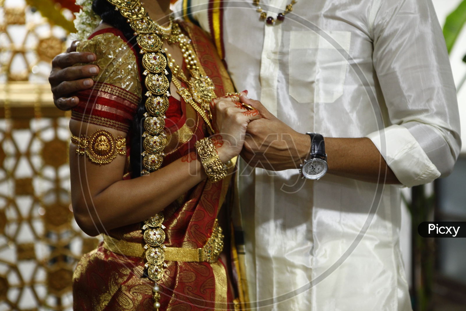 Indian bridegroom and bride holding close to each other