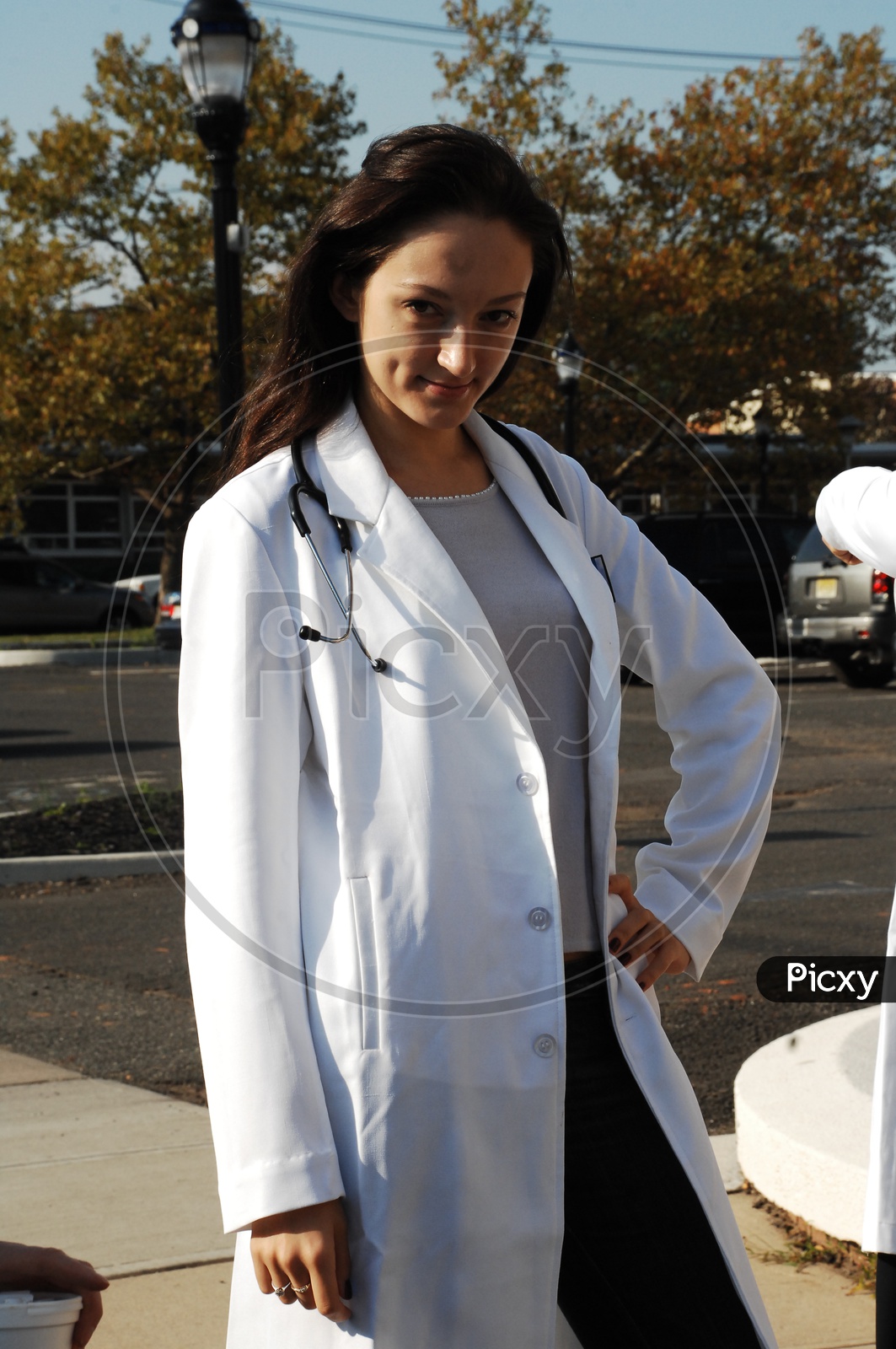 A female doctor with stethoscope wearing a long white coat