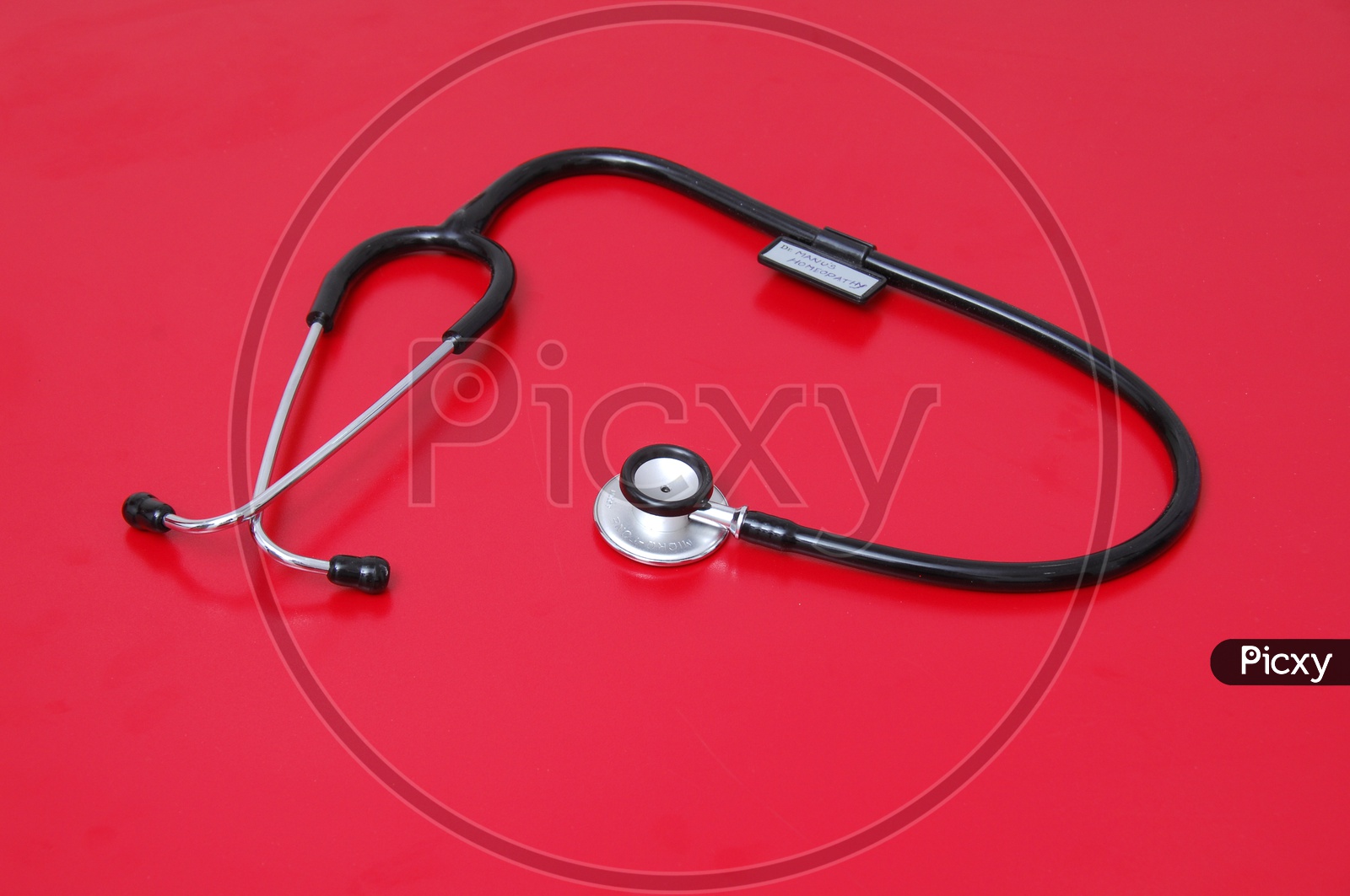 Photograph of stethoscope on red background