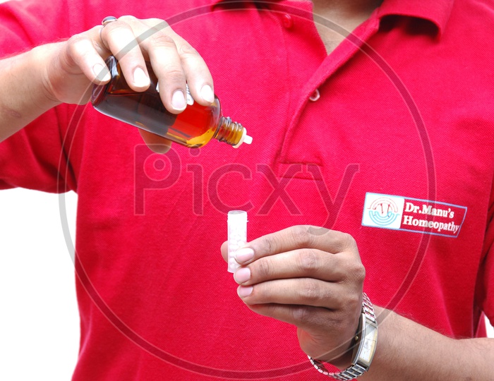 A Pharmacist Mixing The homeopathy Medicine in Bottles closeup