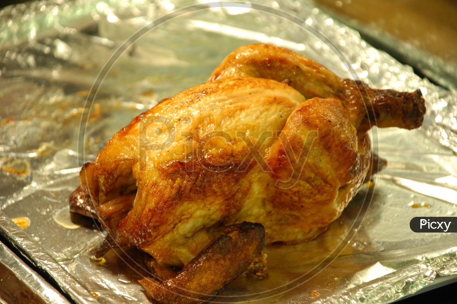 Roasted turkey placed on an aluminum foil lined tray