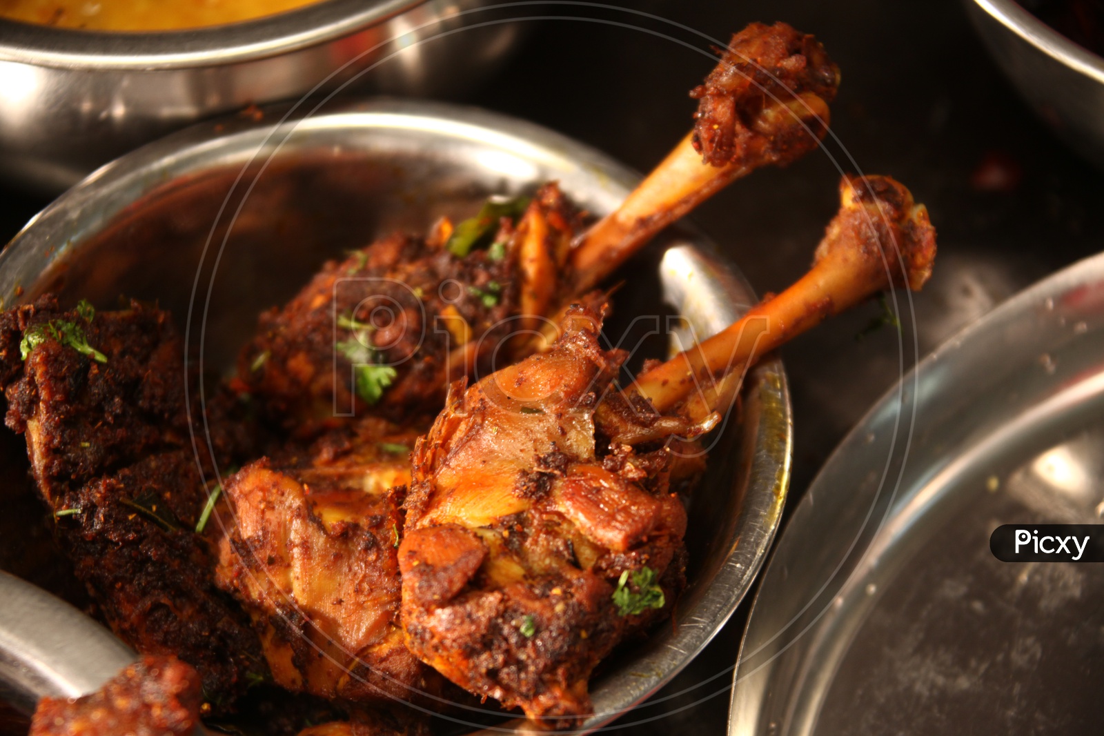 Tandoori chicken in a stainless steel dish