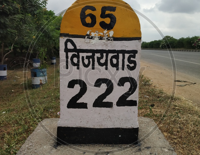 Mile stone showing 222 kms away from Vijayawada
