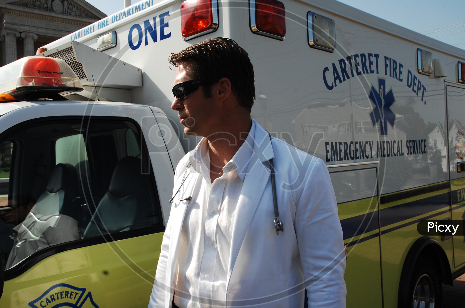 A male doctor standing at the ambulance