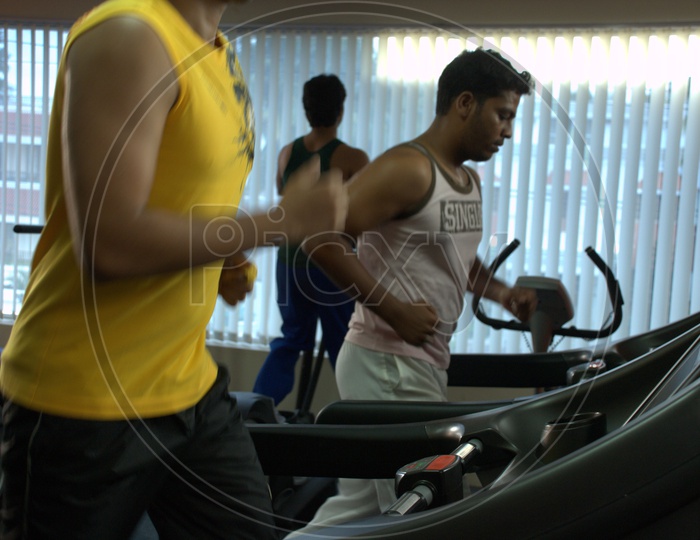 A man running on the Treadmill in a Gym