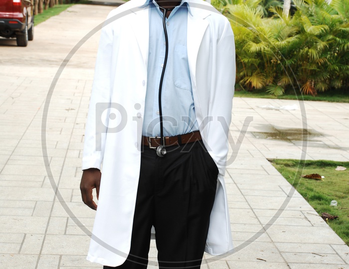A male doctor with a white coat and stethoscope