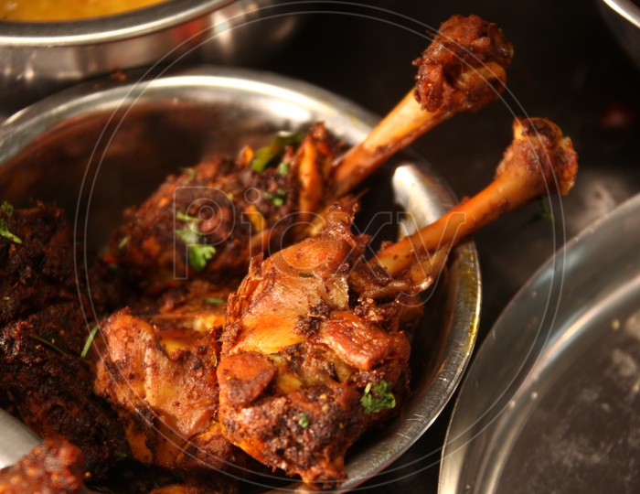 Tandoori chicken in a stainless steel dish
