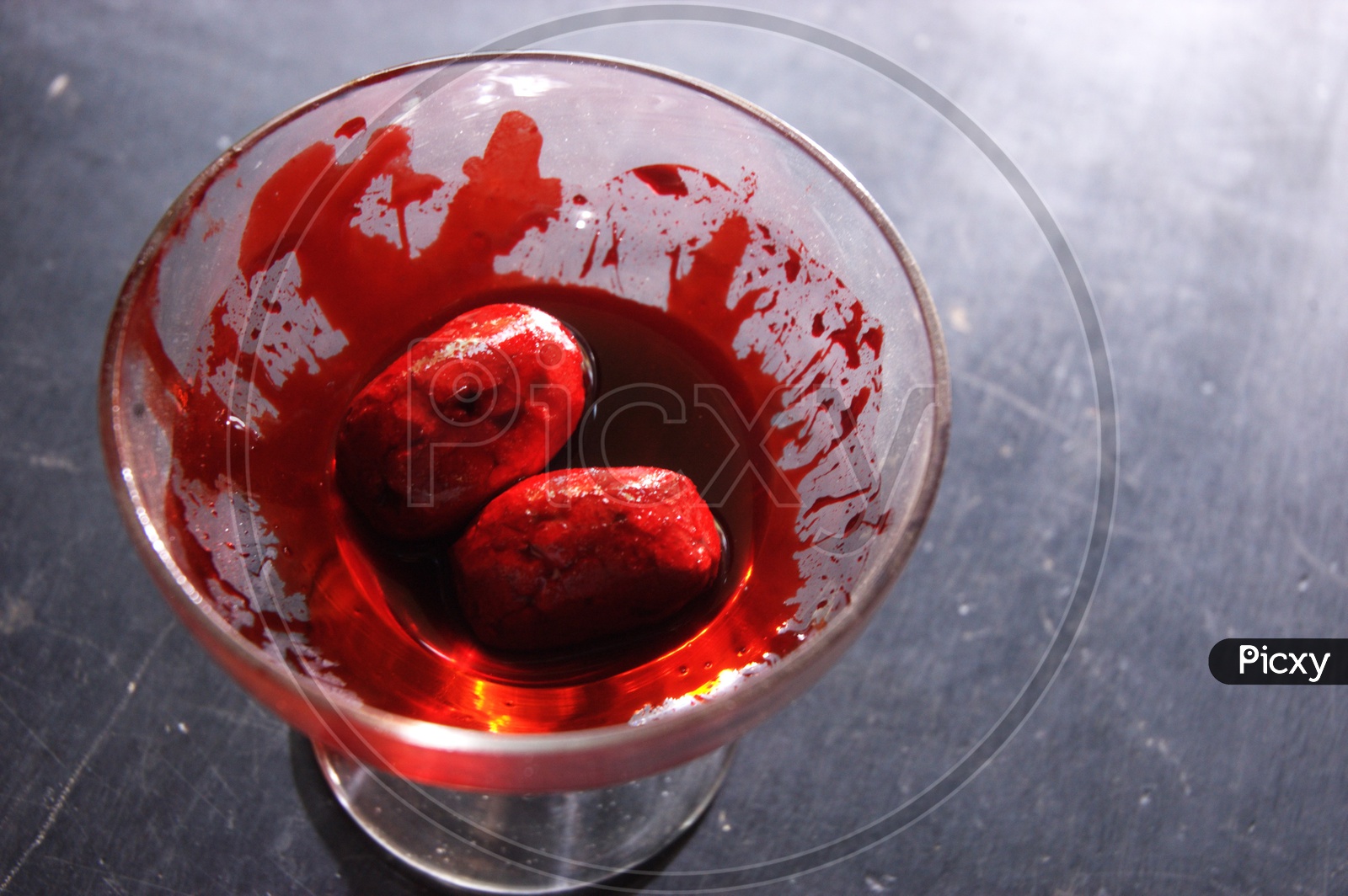 A glass filled with red liquid which looks like blood - Movie scene
