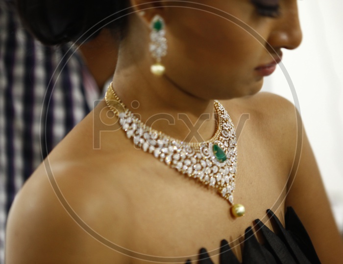 Woman model wearing choker necklace with red Emerald and pearls
