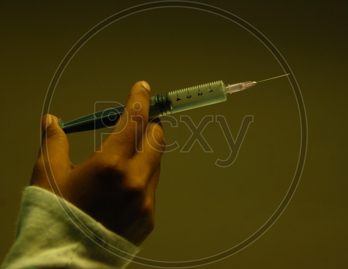 Close up shot of Syringe holding in Hand