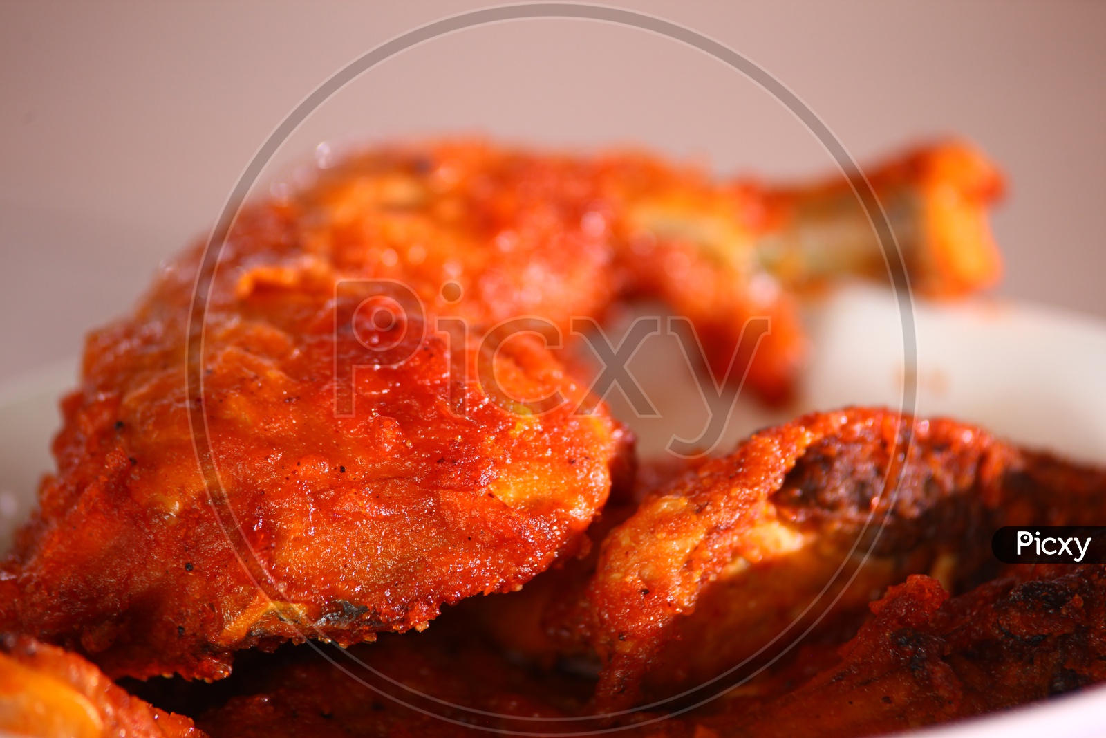 Close up shot of a chicken fry leg piece in a white bowl