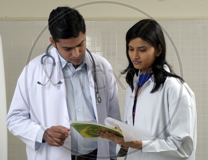 Doctors checking reports of a Patient