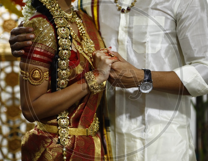 Indian bridegroom and bride holding close to each other