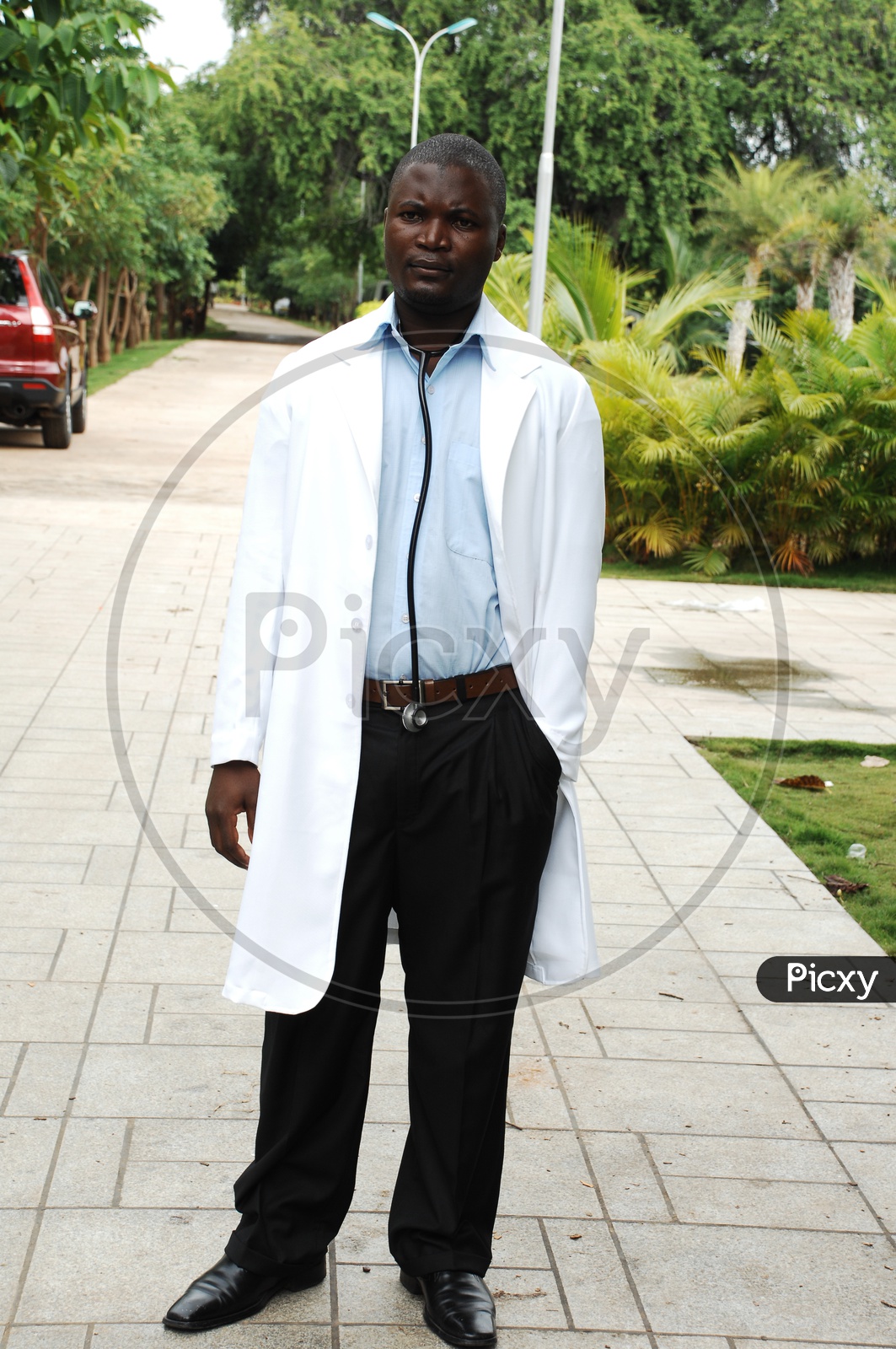 A male doctor with a white coat and stethoscope