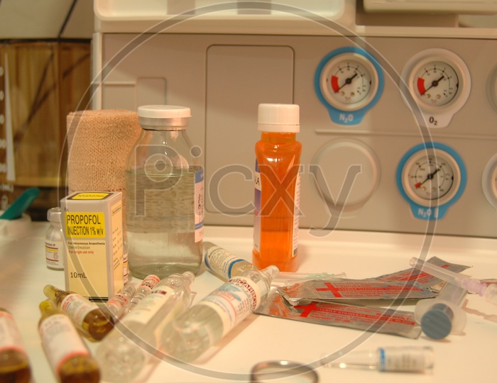 Medicine Bottles On a table With Syringe