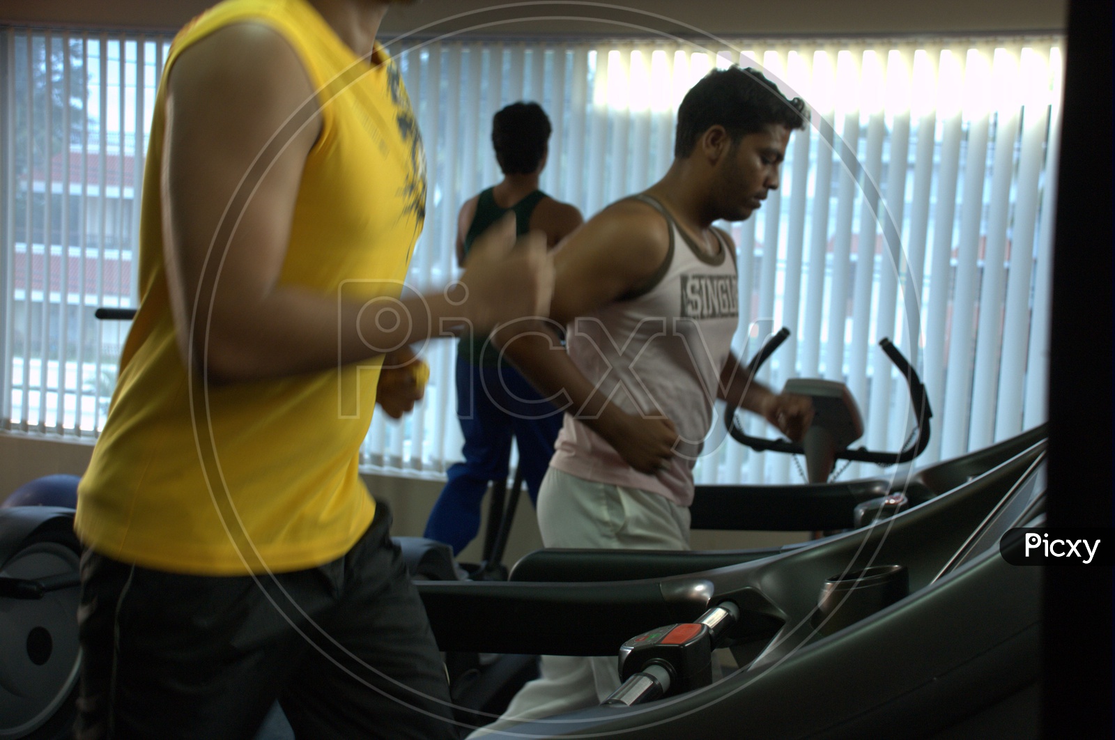 A man running on the Treadmill in a Gym