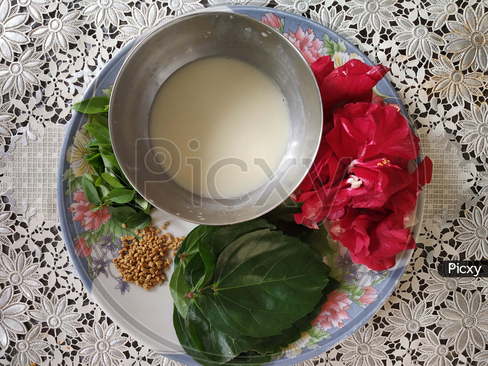 Hair pack Ingredients - Hibiscus leaves and flowers, menthi seeds, alla juice and curry leaves
