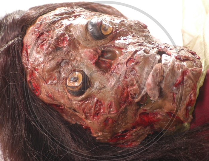 A burnt face mask on a woman - Movie Scene