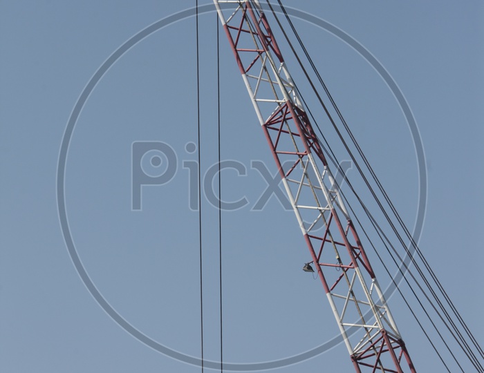 Crane hook attached to the wire with blue sky in background