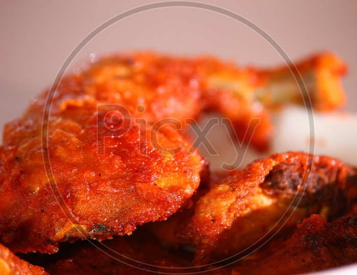 Close up shot of a chicken fry leg piece in a white bowl