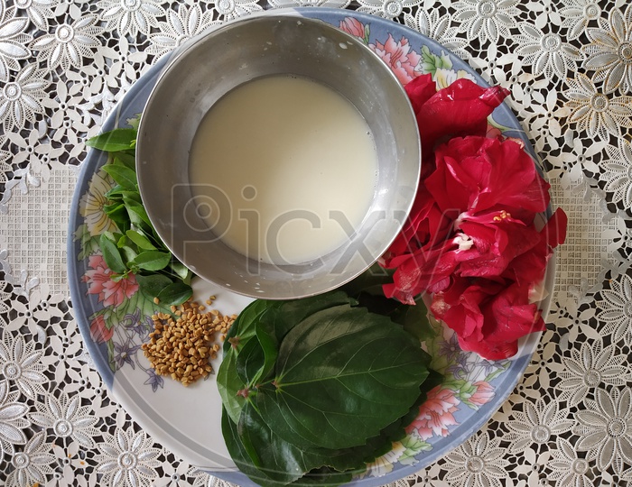 Hair pack Ingredients - Hibiscus leaves and flowers, menthi seeds, alla juice and curry leaves