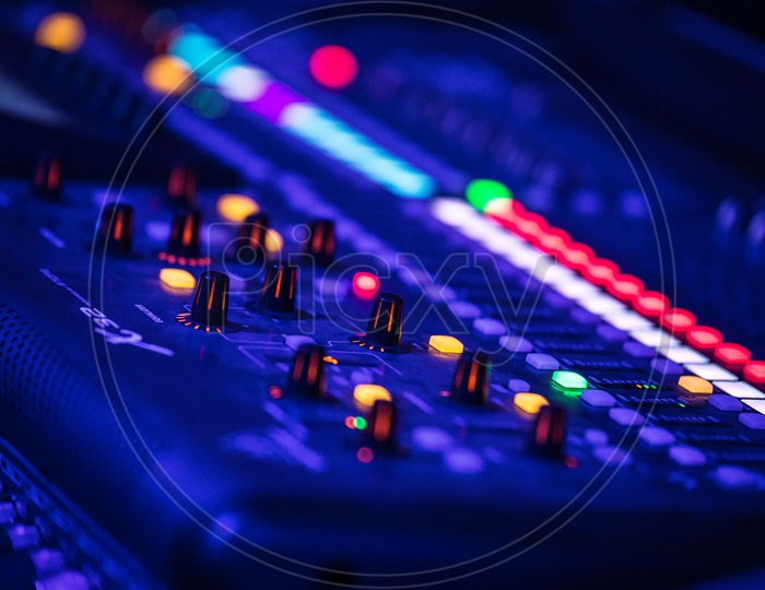 DJ Audio Mixing Amplifier With Closeup Of Buttons in a Pub